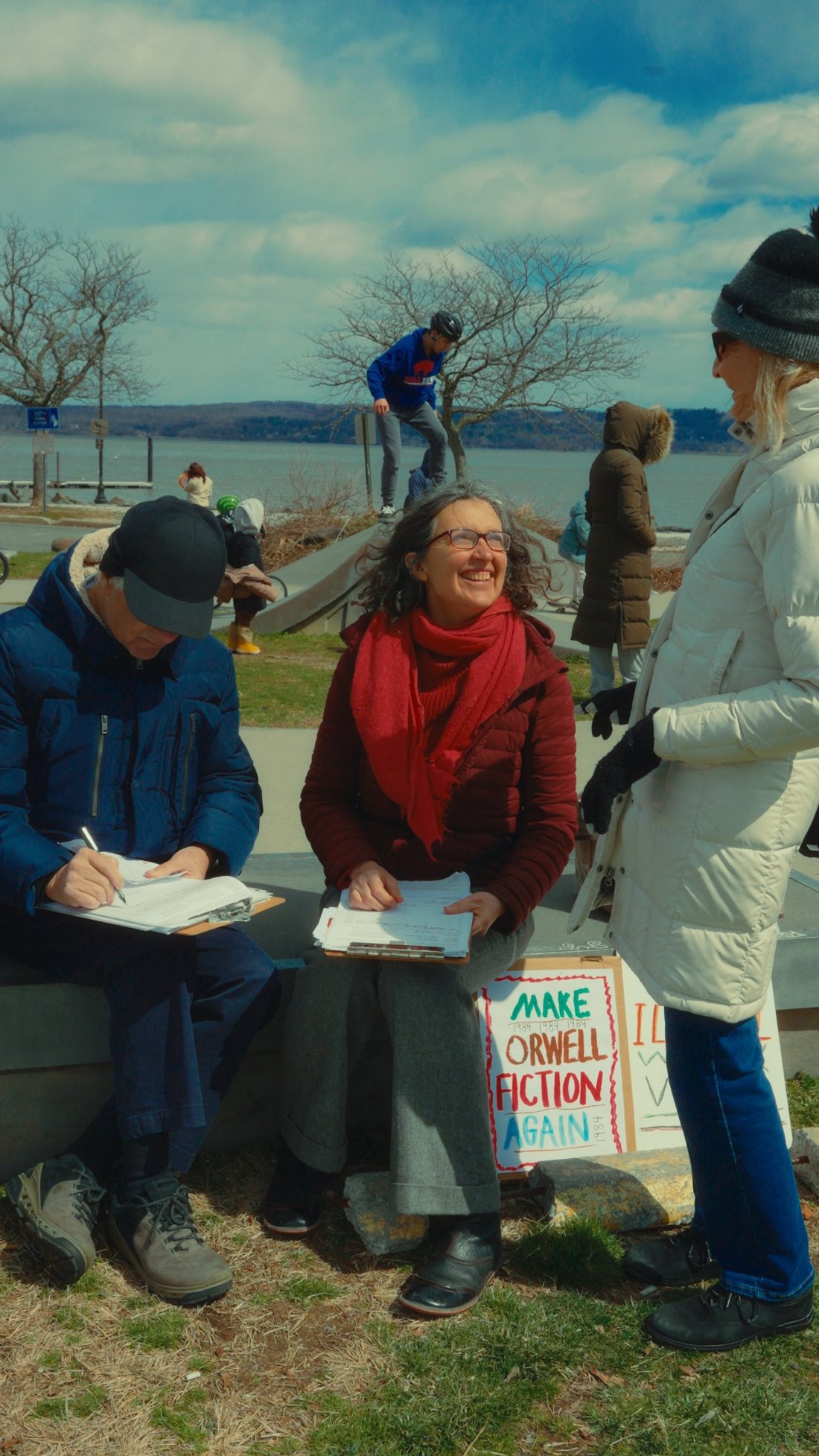 Sylke Jackson smiling up at a neighbor while collecting petition signatures at the Nyack waterfront